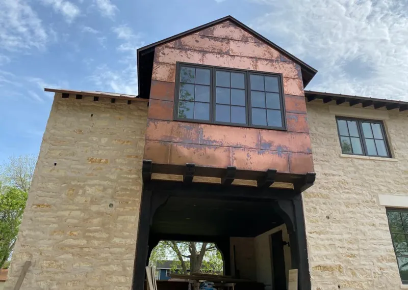 Copper metal panel facade on a stone building for Skylight Installation in Morton Grove