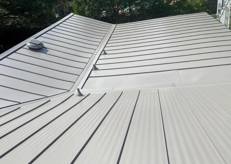 Solar attic fan installed on a metal roof for Roof Ventilation in Morton Grove