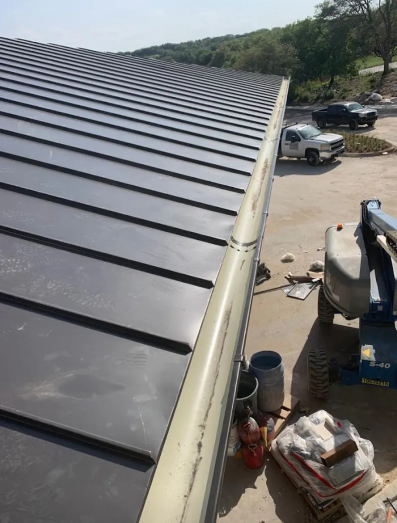 Standing seam panel and gutter detail on a metal roofing jobsite in Morton Grove